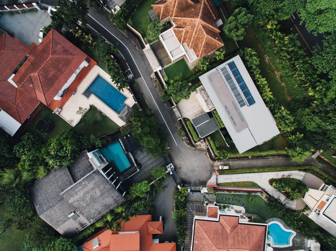 Aerial view of residential houses, gardens and a street